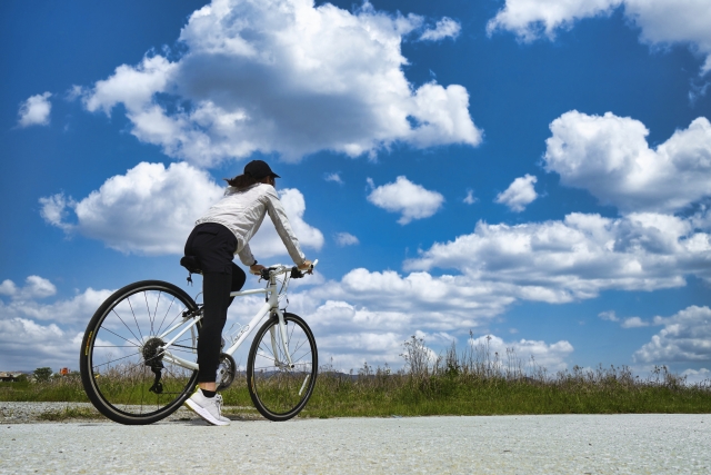 格安ツアーで節約のために自転車に乗る女性の画像