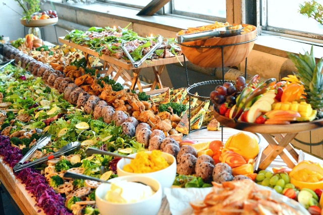 小浜島の飲食店で提供される豪華な宴会・パーティー料理。島のおにぎりやフルーツが並ぶグルメビュッフェ。